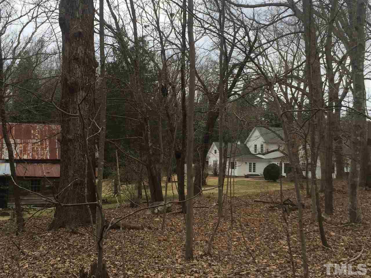 1188 Old Lystra Road Chapel Hill, NC 27517 - Photo 3 of 15 a backyard of a house with table and chairs