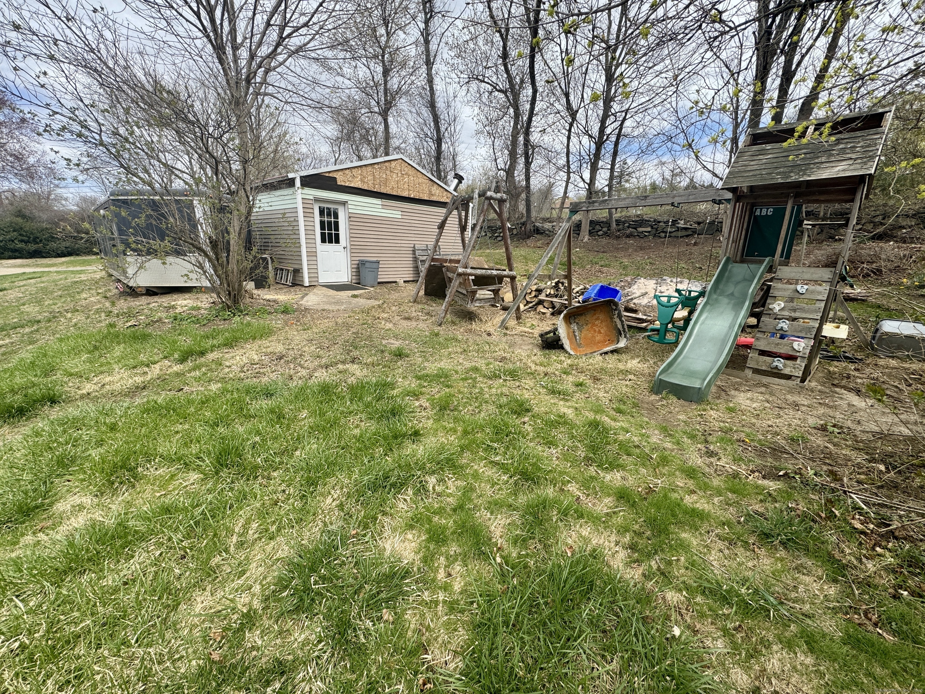 44-46 South Chestnut Street Plainfield, CT 06387 - Photo 11 of 40 a view of a house with a backyard and a tree