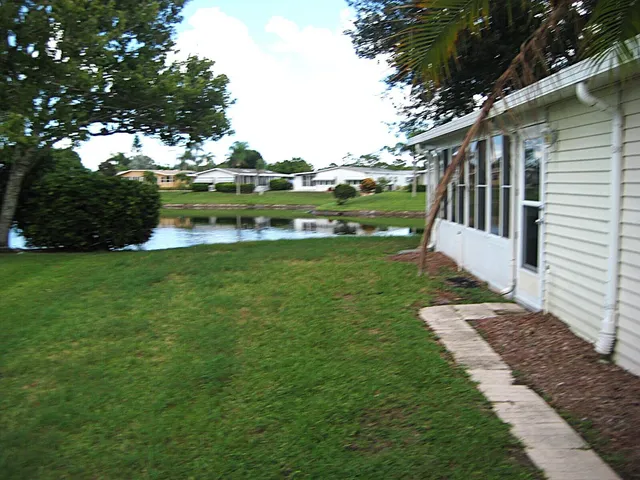 a view of a house with a yard and a patio