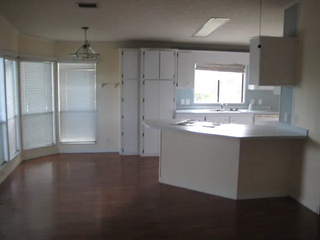 a kitchen with kitchen island a sink appliances and cabinets