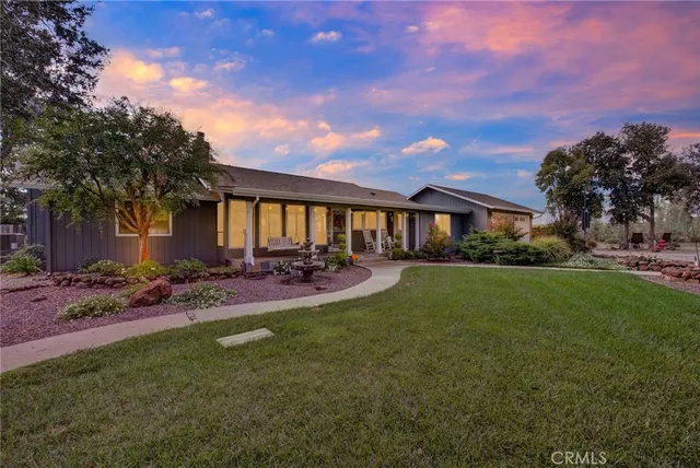 a view of house with outdoor space and garden
