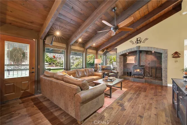 a kitchen with a stove a sink dishwasher a dining table and chairs with wooden floor