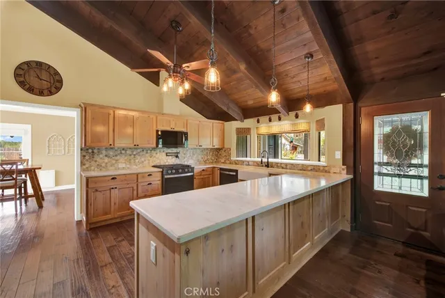 a kitchen with stainless steel appliances a stove microwave and refrigerator