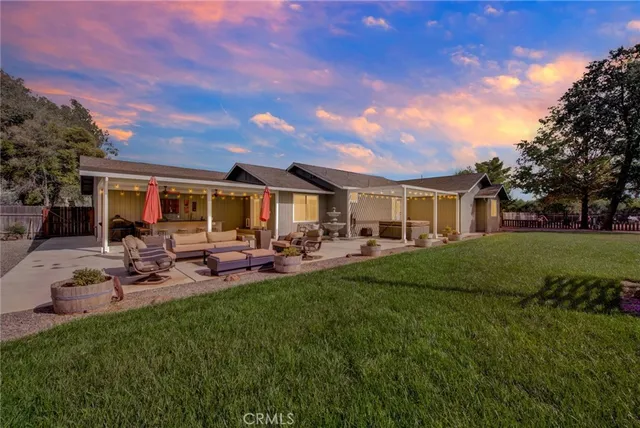 a view of a house with backyard porch and sitting area
