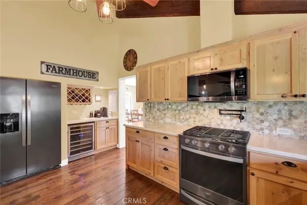 a view of a dining room with furniture a chandelier and wooden floor