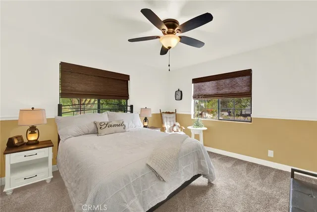 a front view of a house with garden and sitting area