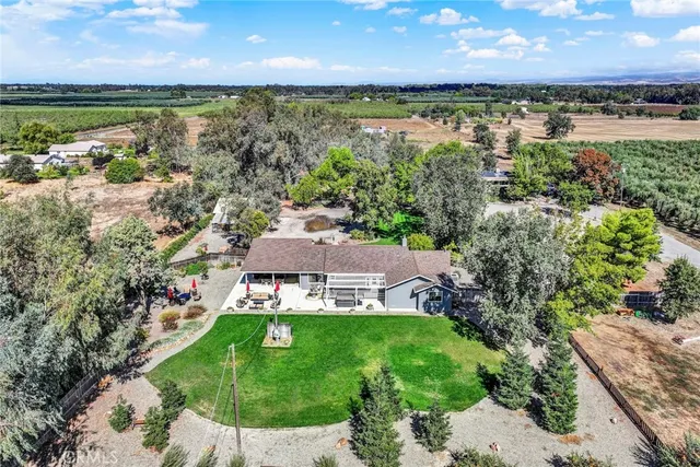 a view of a house with backyard and swimming pool