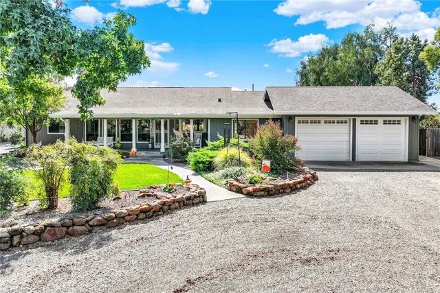 a front view of a house with yard and green space