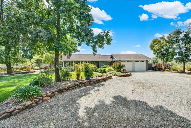 a view of a house with backyard porch and sitting area