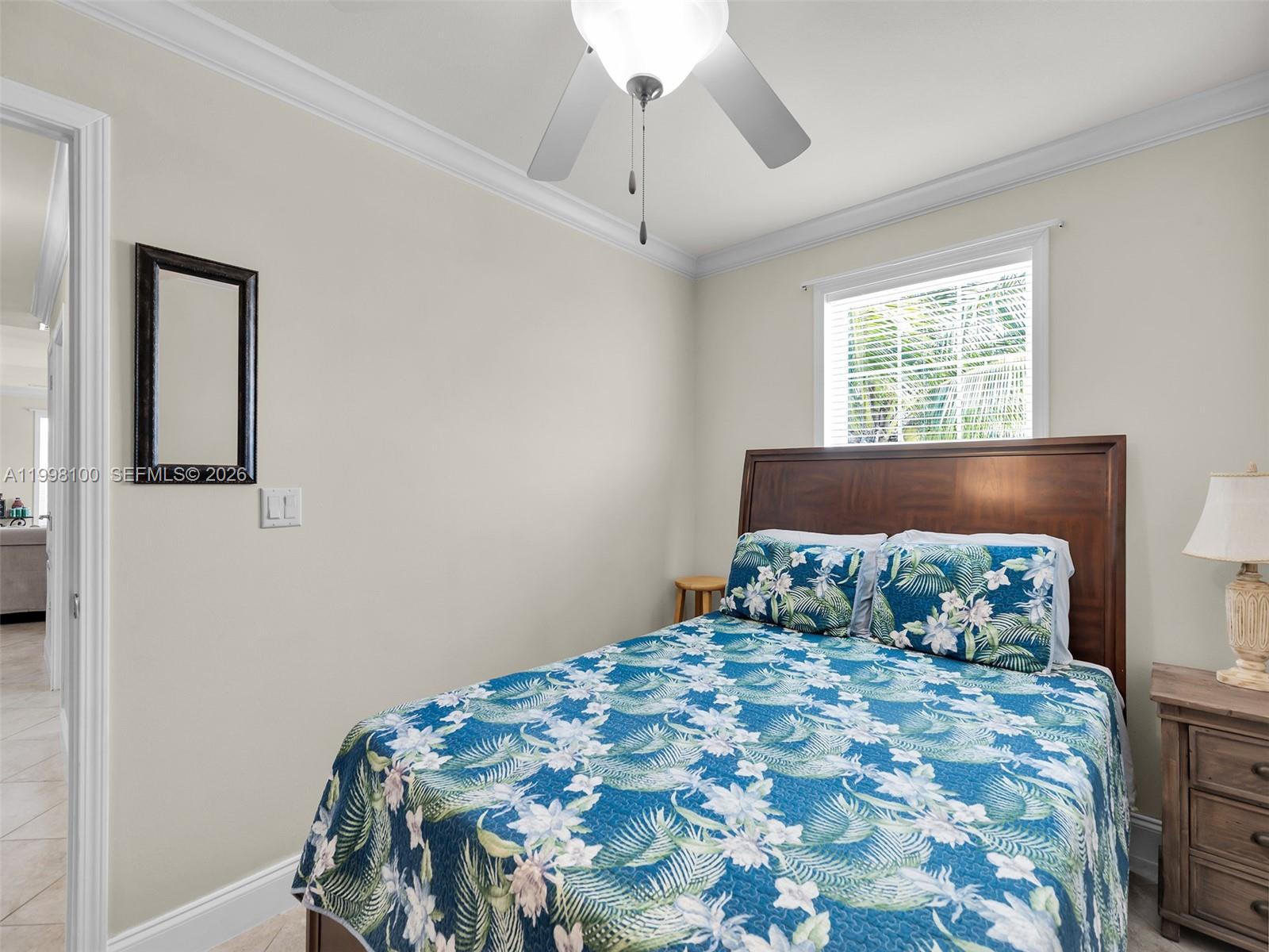 437 Pirates Road Summerland Key, FL 33042 - Photo 29 of 39 a bedroom with a bed and a window