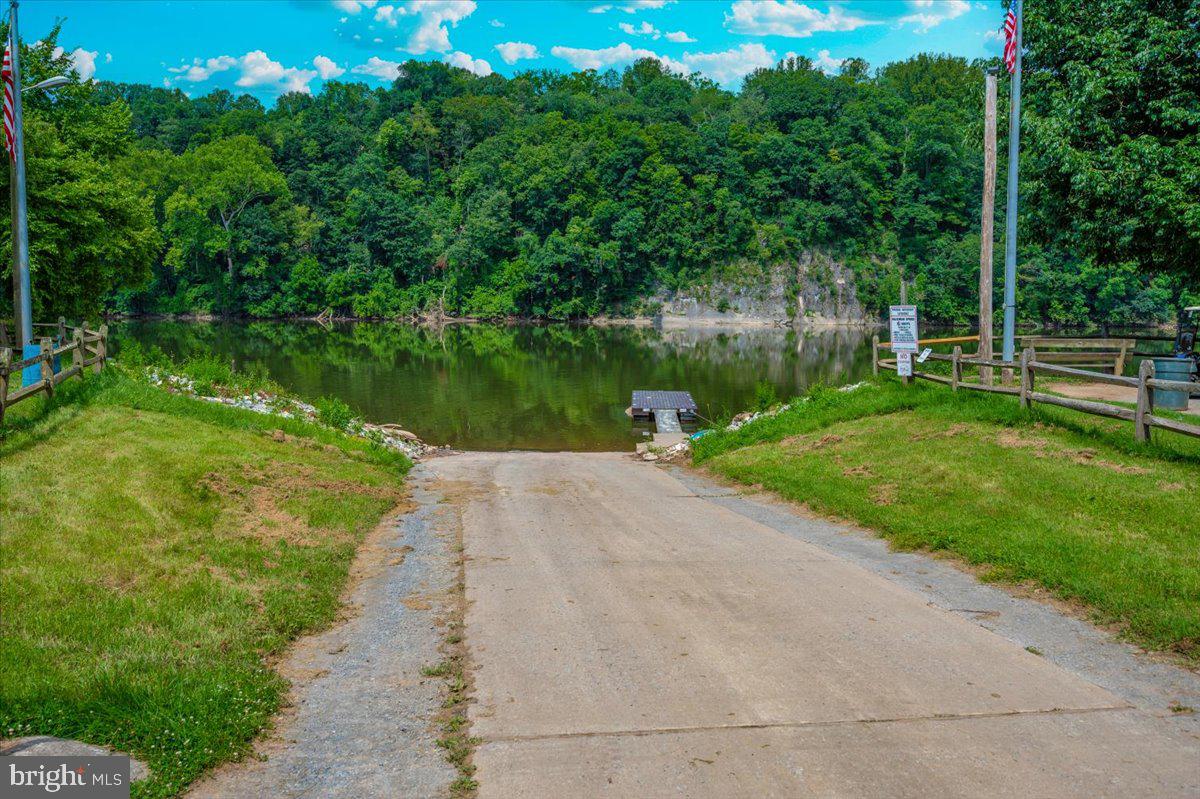 9 Boo Boo Boulevard Falling Waters, WV 25419 - Photo 33 of 40 a view of a lake with a yard and large trees