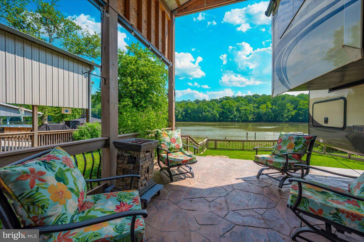 9 Boo Boo Boulevard Falling Waters, WV 25419 - Photo 9 of 40 a view of a chairs and table in patio with wooden floor