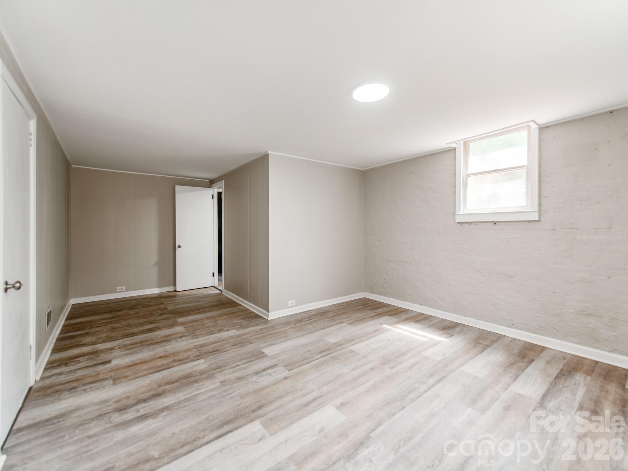 113 Falls Street Morganton, NC 28655 - Photo 26 of 33 a view of an empty room with wooden floor and a window