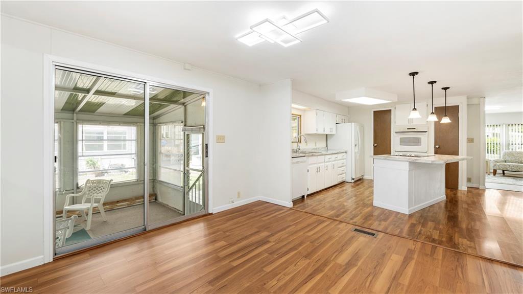 250 Indian Key Lane Naples, FL 34114 - Photo 11 of 33 a view of a kitchen with wooden floor and a kitchen