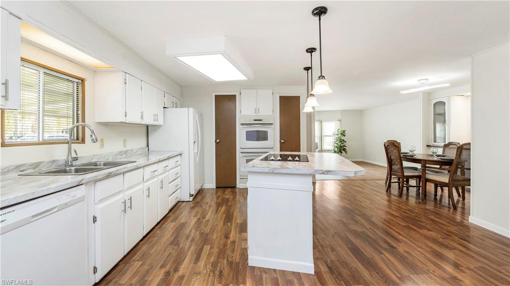 250 Indian Key Lane Naples, FL 34114 - Photo 12 of 33 a kitchen with stainless steel appliances granite countertop sink stove top oven and cabinets