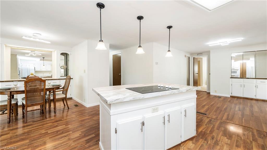 250 Indian Key Lane Naples, FL 34114 - Photo 14 of 33 a kitchen with a table chairs and wooden floor