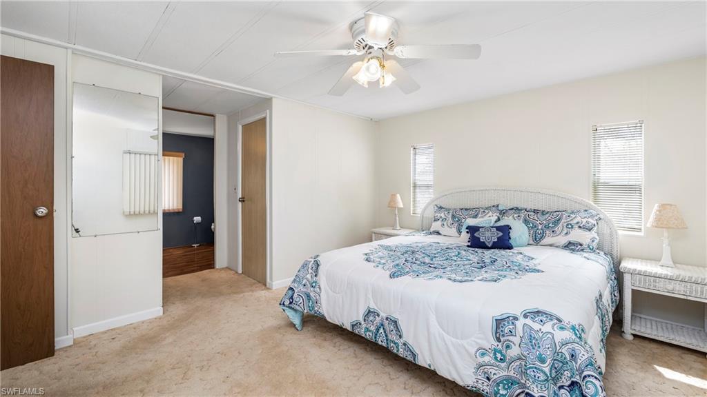 250 Indian Key Lane Naples, FL 34114 - Photo 16 of 33 a bedroom with a bed and a chandelier