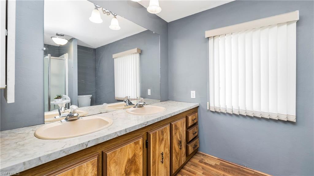 250 Indian Key Lane Naples, FL 34114 - Photo 17 of 33 a bathroom with a granite countertop sink and a mirror
