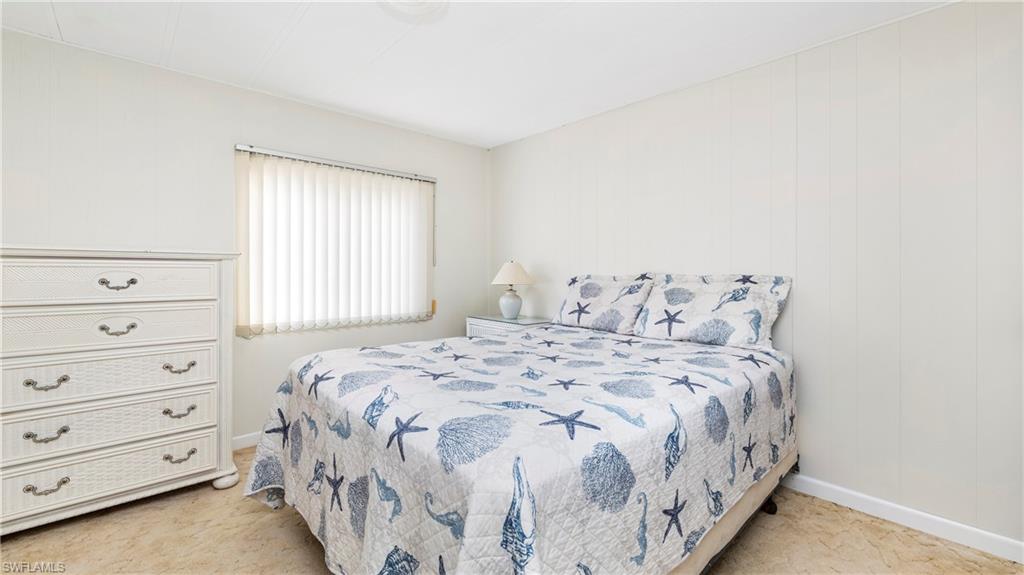 250 Indian Key Lane Naples, FL 34114 - Photo 20 of 33 a bedroom with a bed and a window