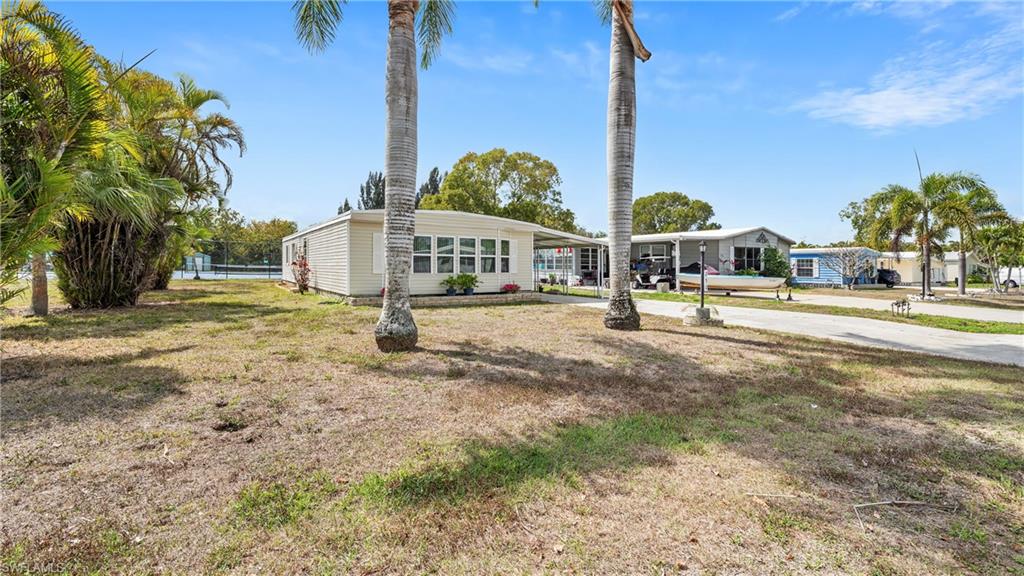 250 Indian Key Lane Naples, FL 34114 - Photo 3 of 33 a view of a large house with large trees and plants