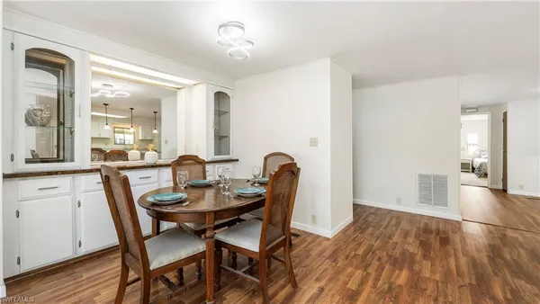 a view of a dining room with furniture and wooden floor