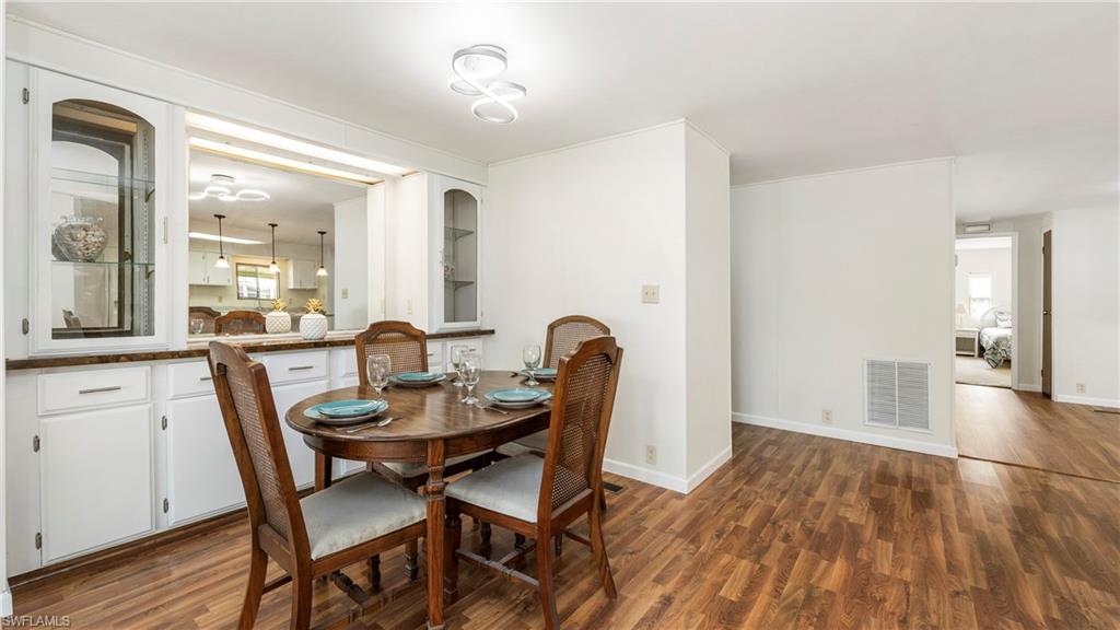 250 Indian Key Lane Naples, FL 34114 - Photo 6 of 33 a view of a dining room with furniture and wooden floor