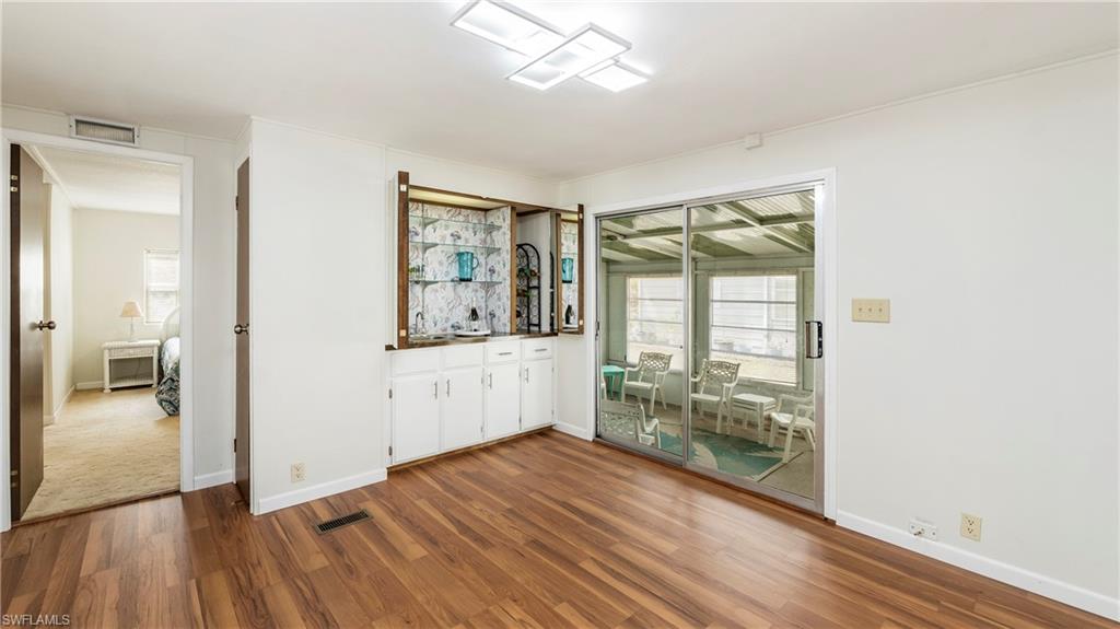 250 Indian Key Lane Naples, FL 34114 - Photo 9 of 33 a view of a hallway with wooden floor and a living room