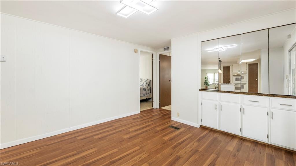 250 Indian Key Lane Naples, FL 34114 - Photo 10 of 33 a view of a kitchen with wooden floor and white walls