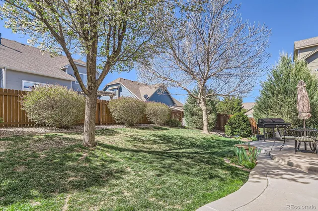 a tree in front of a white house