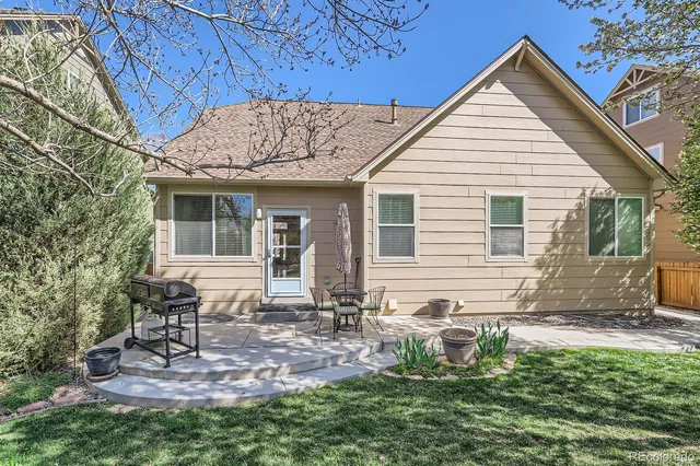 a view of a house with a yard and sitting area