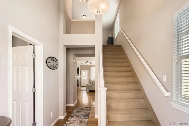 a view of a hallway with entryway wooden floor and front door
