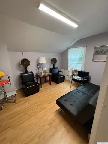 a kitchen with granite countertop wooden floors a stove and a refrigerator