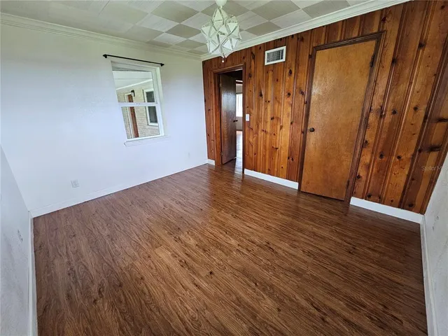a view of a hallway with wooden floor and stairs