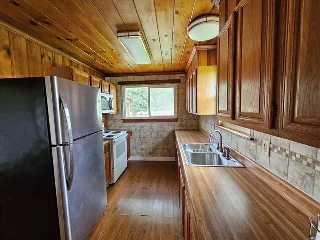 a kitchen with a sink a refrigerator freezer a washer and dryer