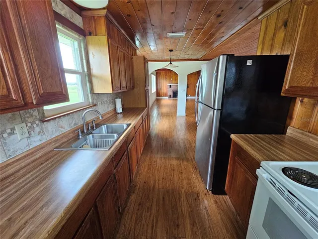 a kitchen with sink and refrigerator