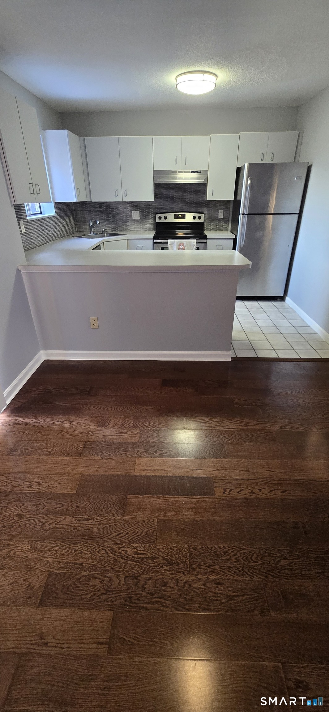 925 Oronoke Road, Unit 12C Waterbury, CT 06708 - Photo 17 of 20 a view of kitchen with stainless steel appliances a refrigerator and a stove top oven