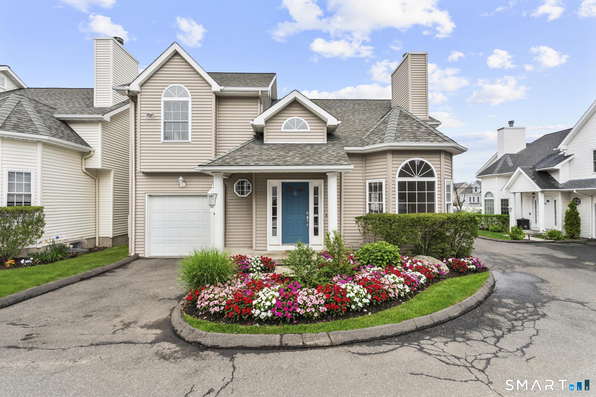168 Colonial Road, Unit 6 Stamford, CT 06906 - Photo 1 of 41 a front view of a house with a garden