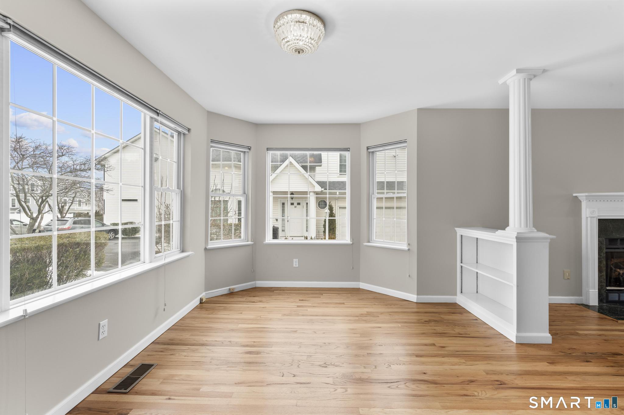 168 Colonial Road, Unit 6 Stamford, CT 06906 - Photo 16 of 41 a view of empty room with wooden floor and fan