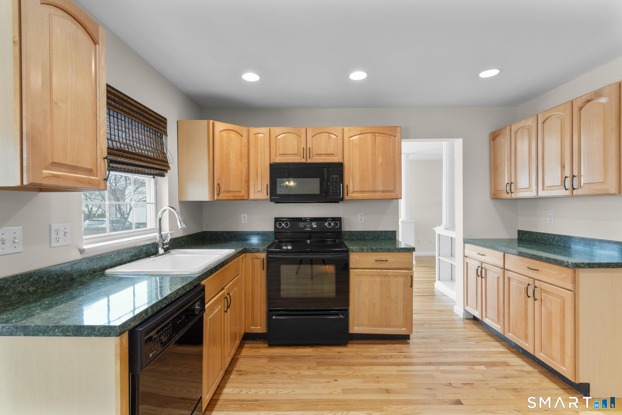 168 Colonial Road, Unit 6 Stamford, CT 06906 - Photo 19 of 41 a kitchen with stainless steel appliances granite countertop a stove a sink and a microwave