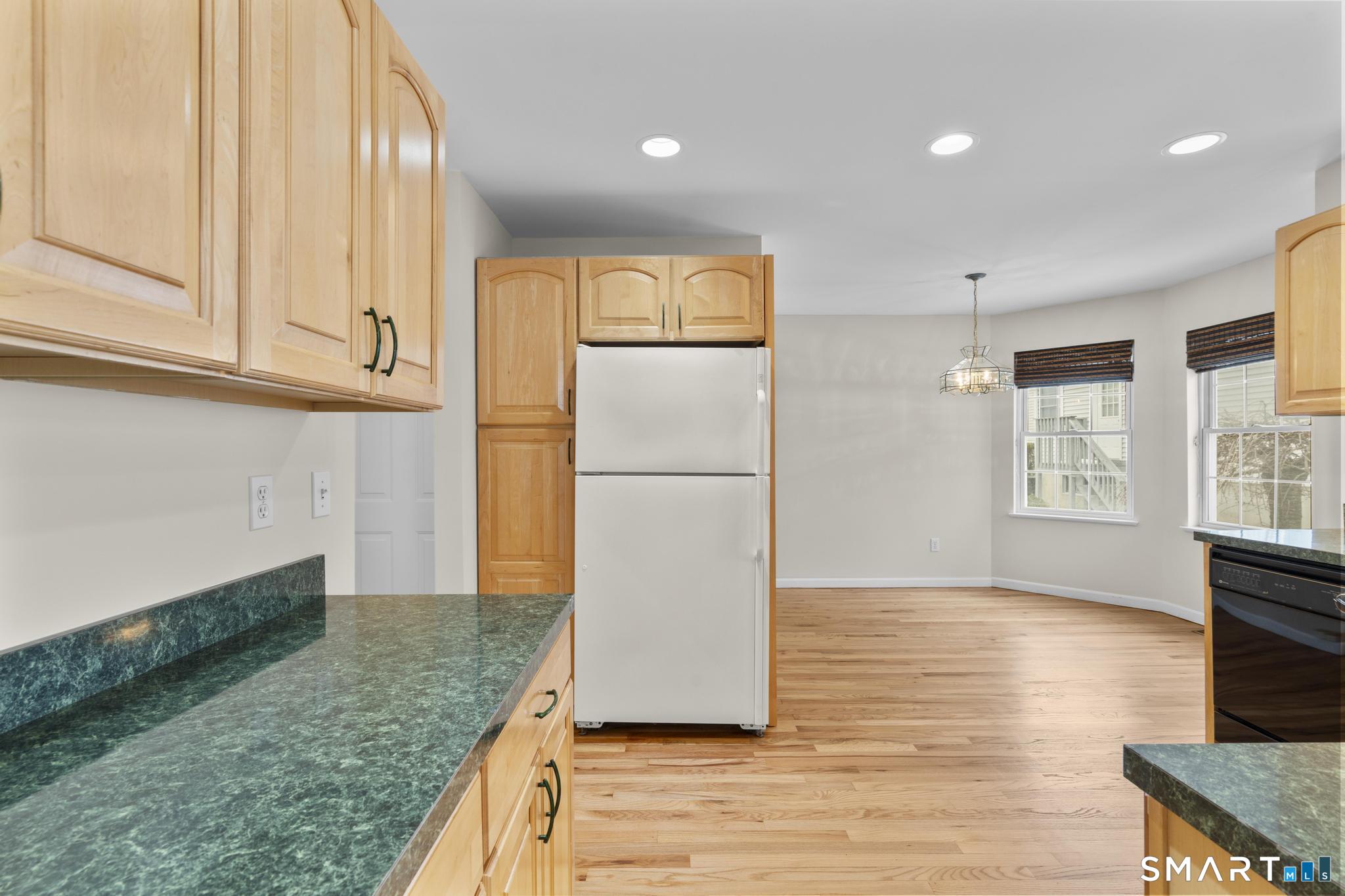 168 Colonial Road, Unit 6 Stamford, CT 06906 - Photo 20 of 41 a kitchen with granite countertop a refrigerator a sink and a stove