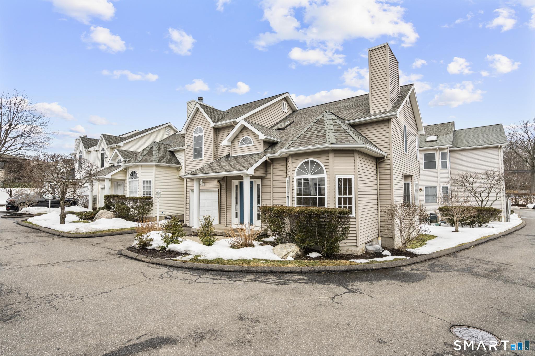 168 Colonial Road, Unit 6 Stamford, CT 06906 - Photo 2 of 41 a front view of a house with a yard