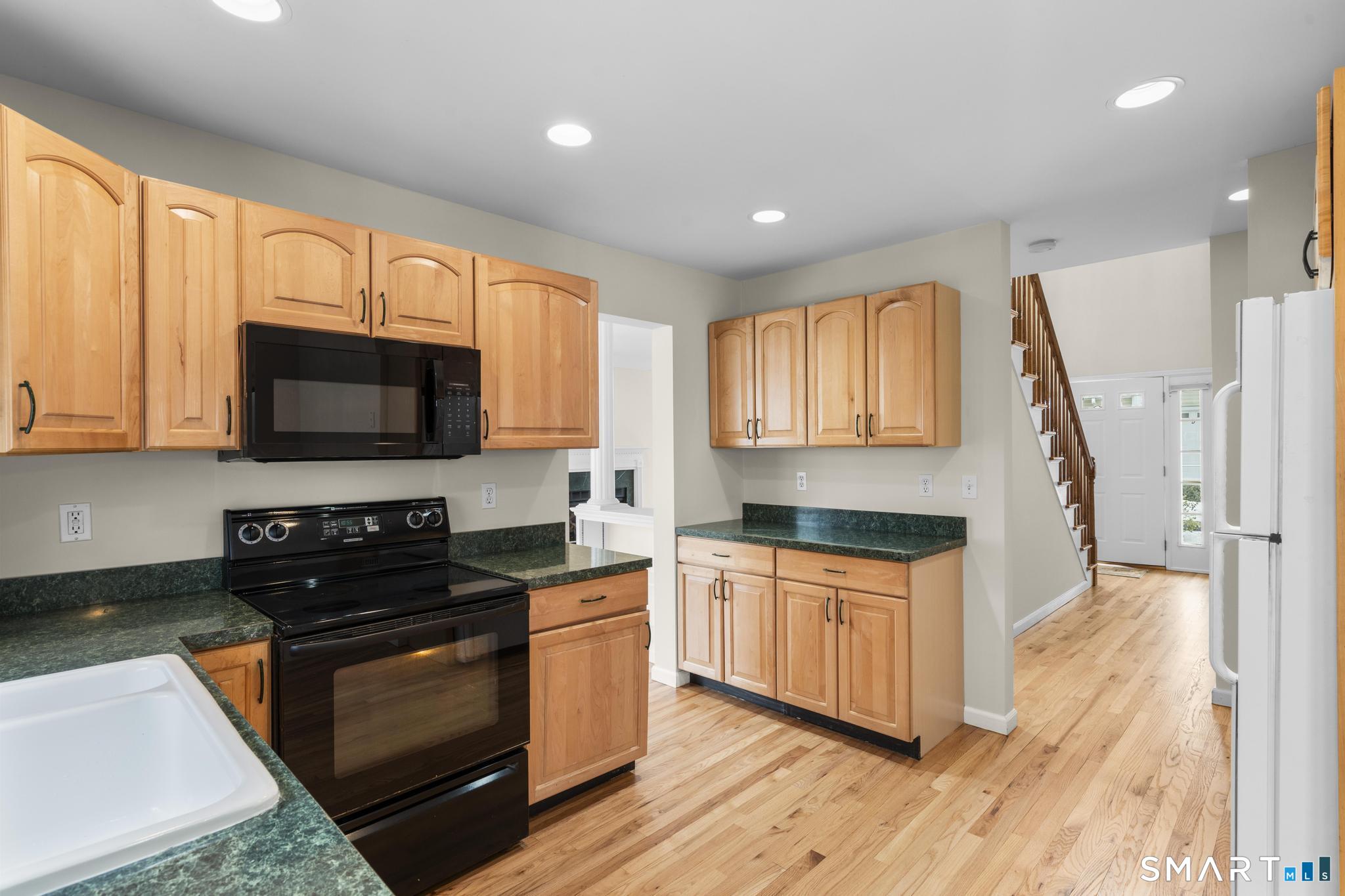 168 Colonial Road, Unit 6 Stamford, CT 06906 - Photo 22 of 41 a kitchen with stainless steel appliances a stove sink and microwave