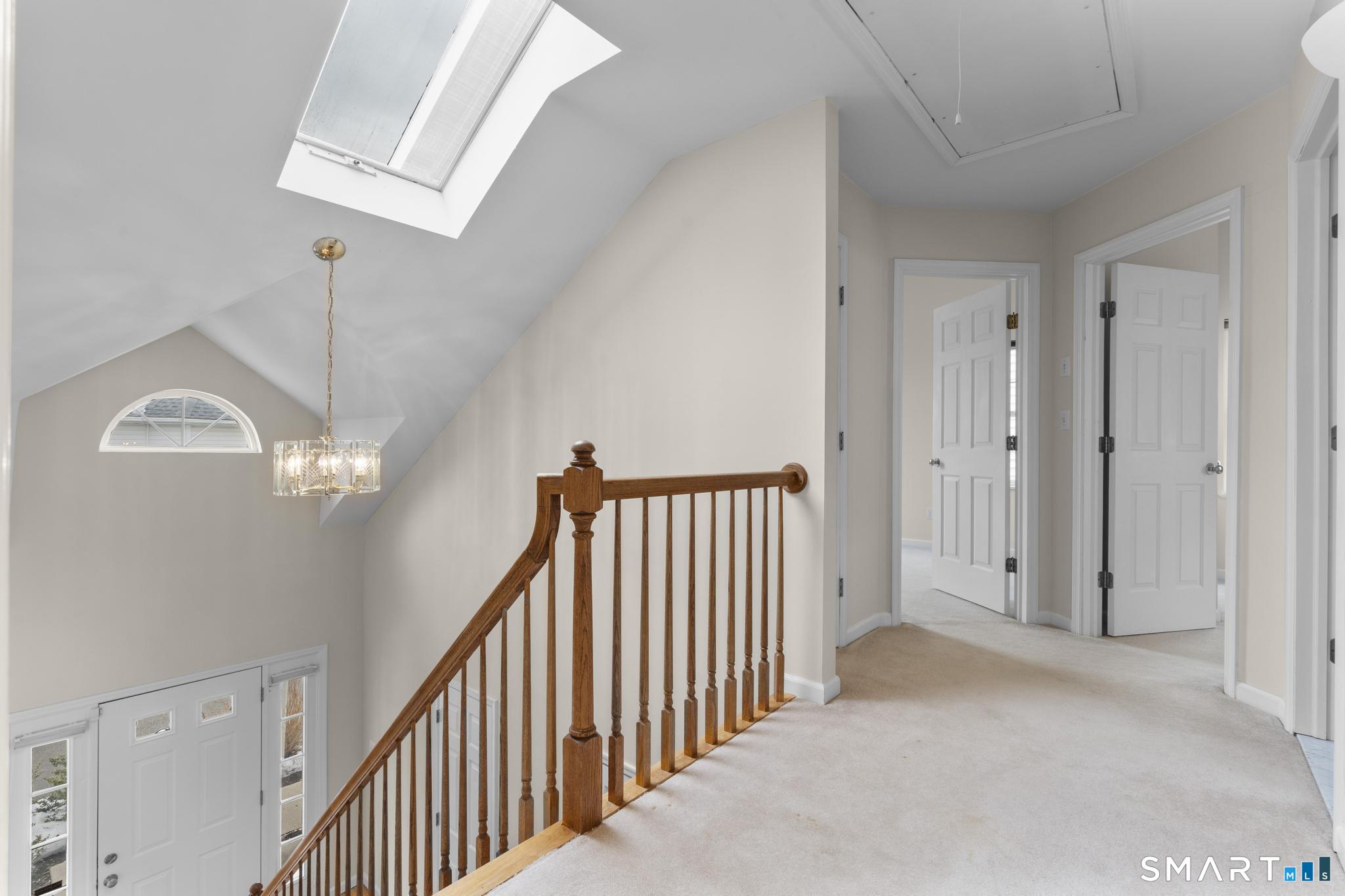 168 Colonial Road, Unit 6 Stamford, CT 06906 - Photo 27 of 41 a view of a hallway with entryway chandelier and front door