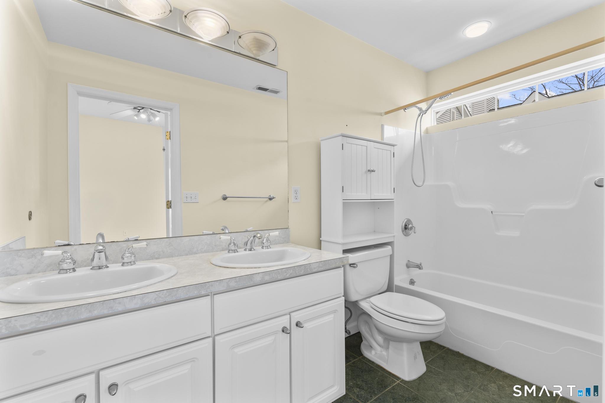 168 Colonial Road, Unit 6 Stamford, CT 06906 - Photo 30 of 41 a bathroom with a granite countertop sink toilet and shower