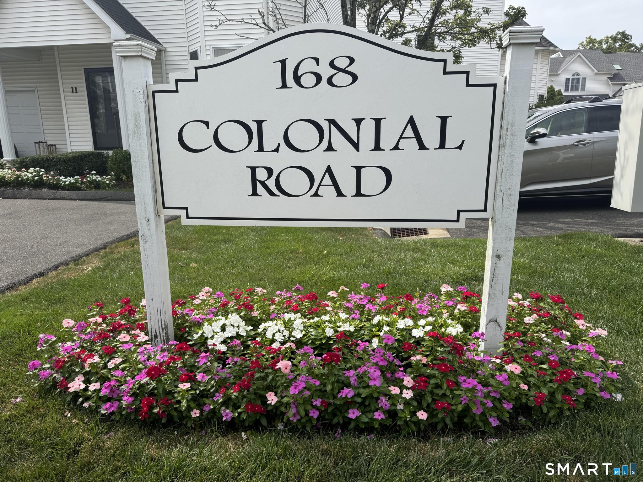 168 Colonial Road, Unit 6 Stamford, CT 06906 - Photo 37 of 41 a view of sign board with yard and flowers