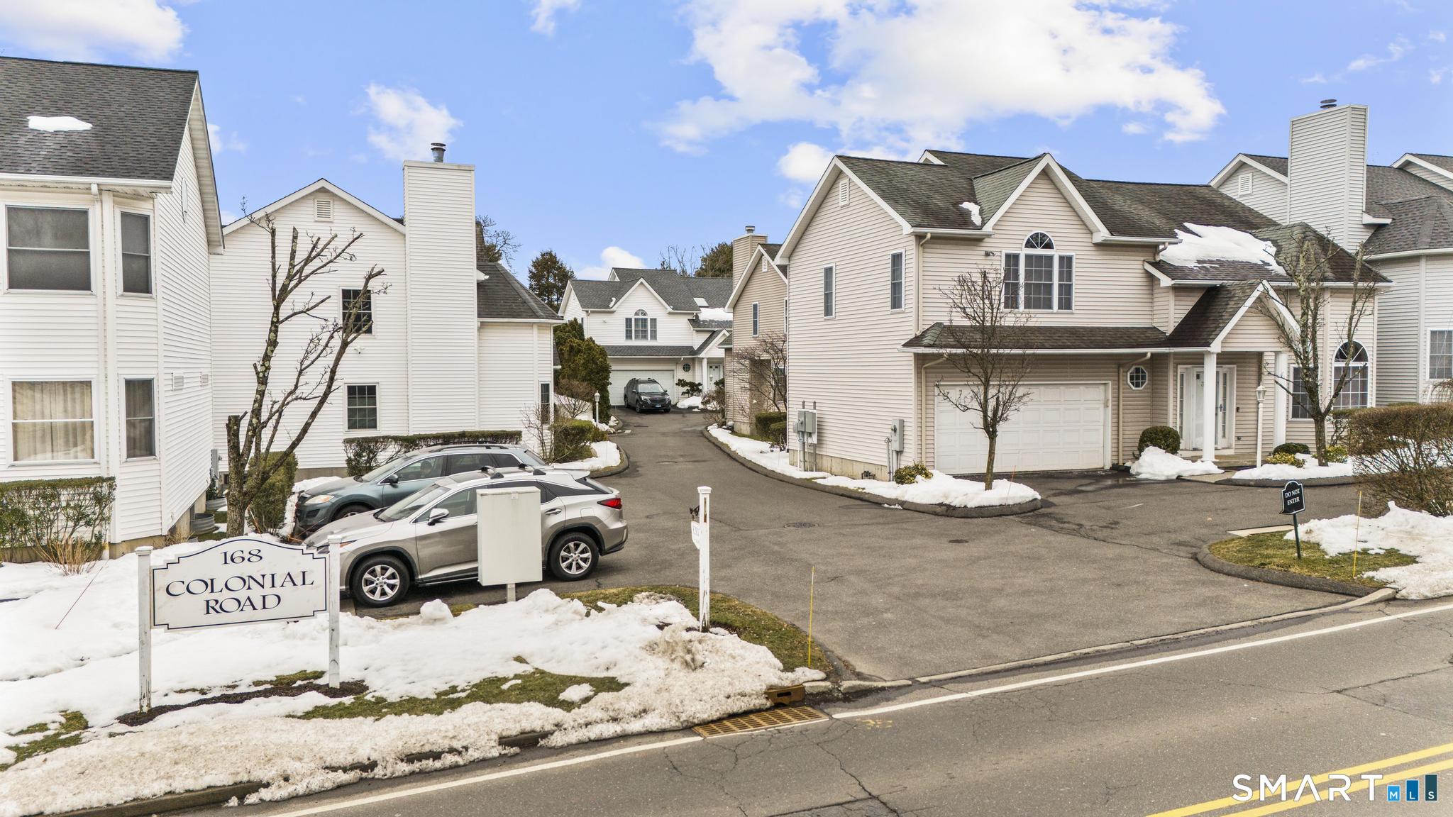 168 Colonial Road, Unit 6 Stamford, CT 06906 - Photo 5 of 41 a view of a white house with wooden fence
