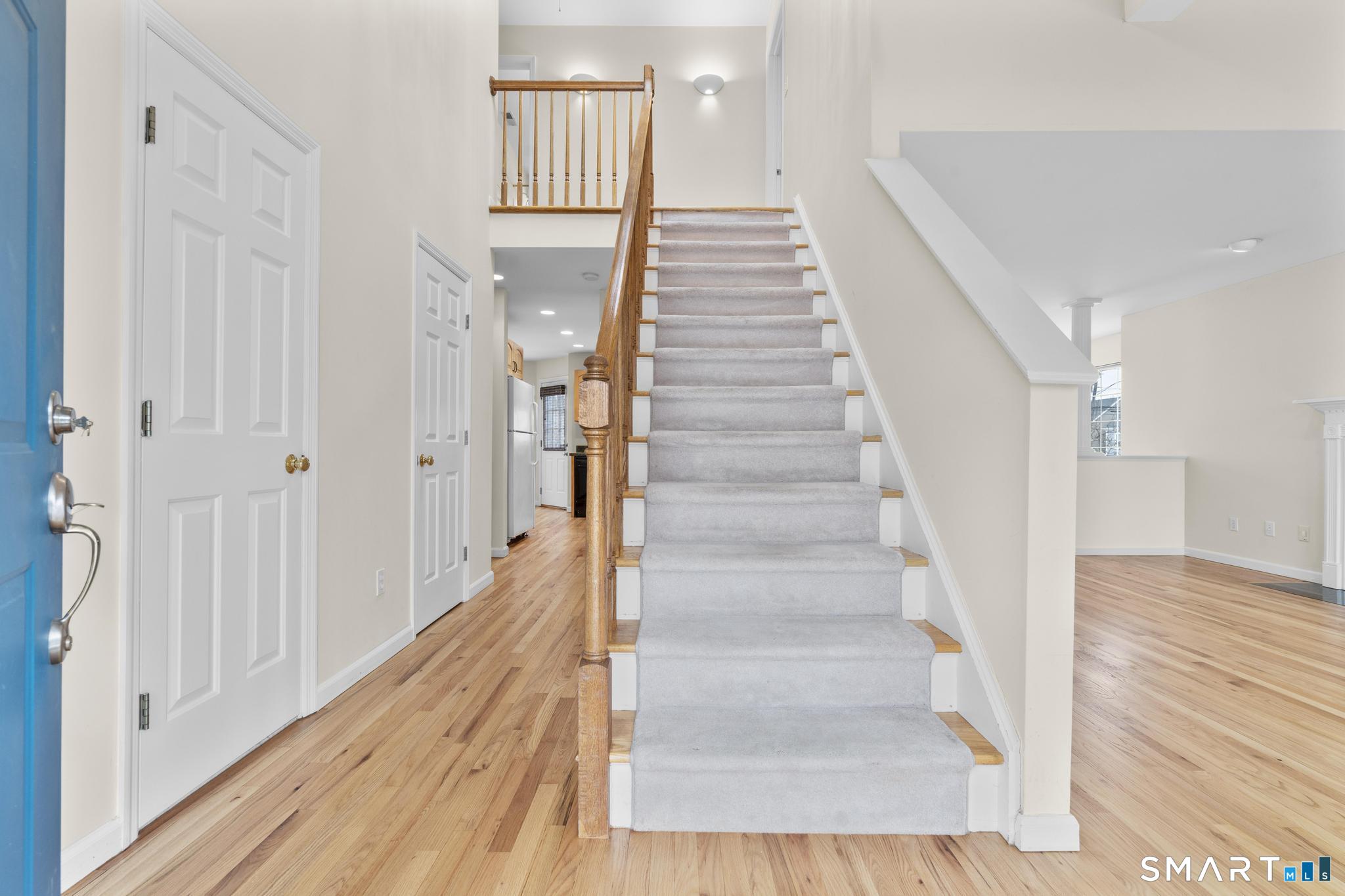 168 Colonial Road, Unit 6 Stamford, CT 06906 - Photo 7 of 41 a view of a hallway with wooden floor and staircase