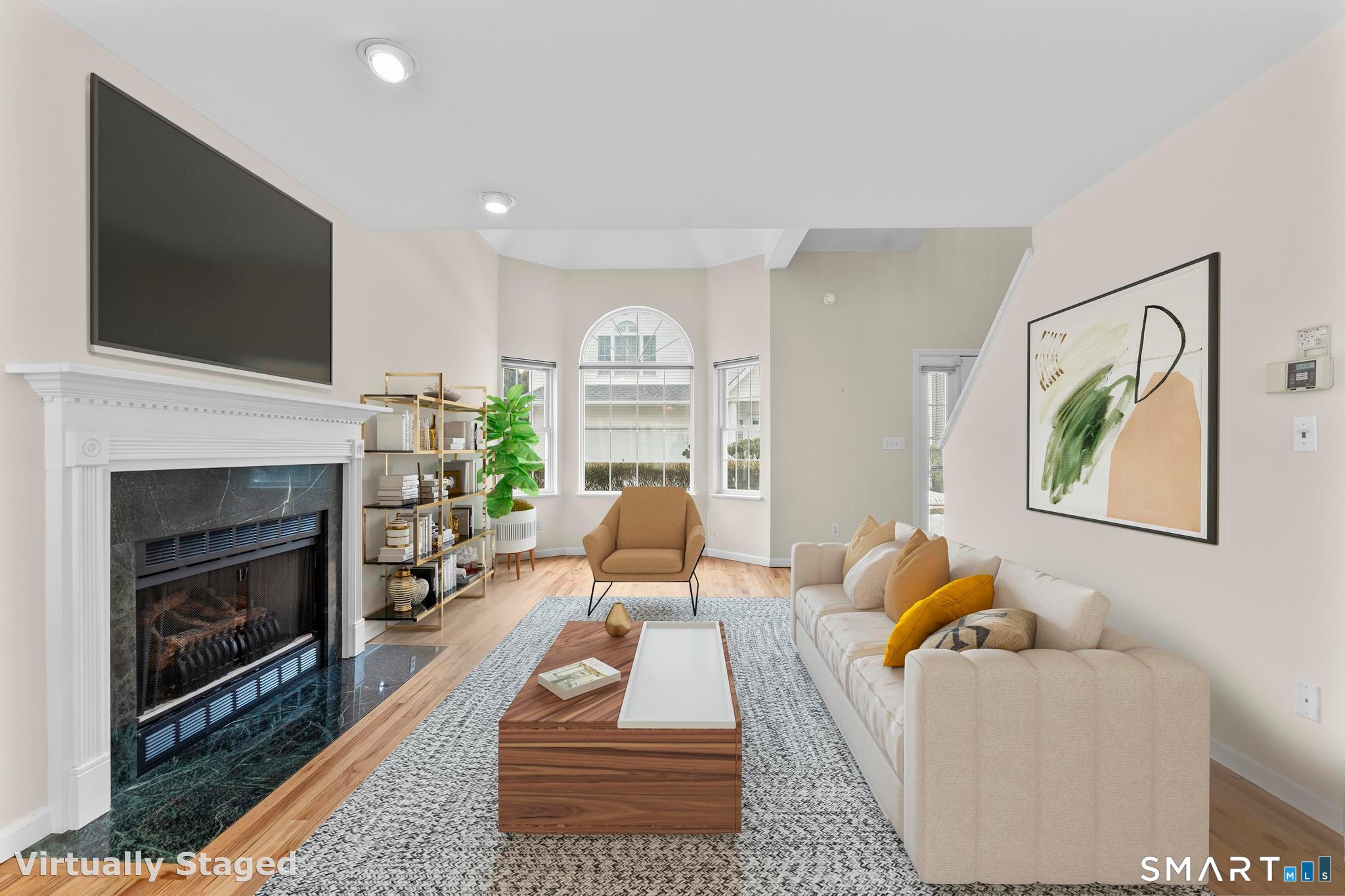 168 Colonial Road, Unit 6 Stamford, CT 06906 - Photo 9 of 41 a living room with furniture a flat screen tv and a fireplace