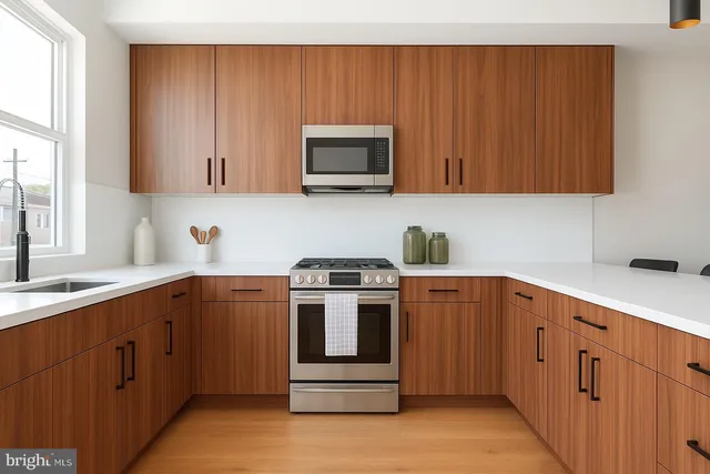 a kitchen with cabinets appliances and a window
