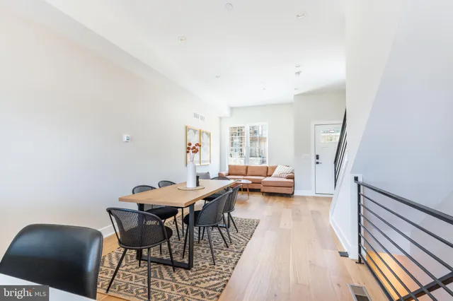 a view of a dining room with furniture and a rug